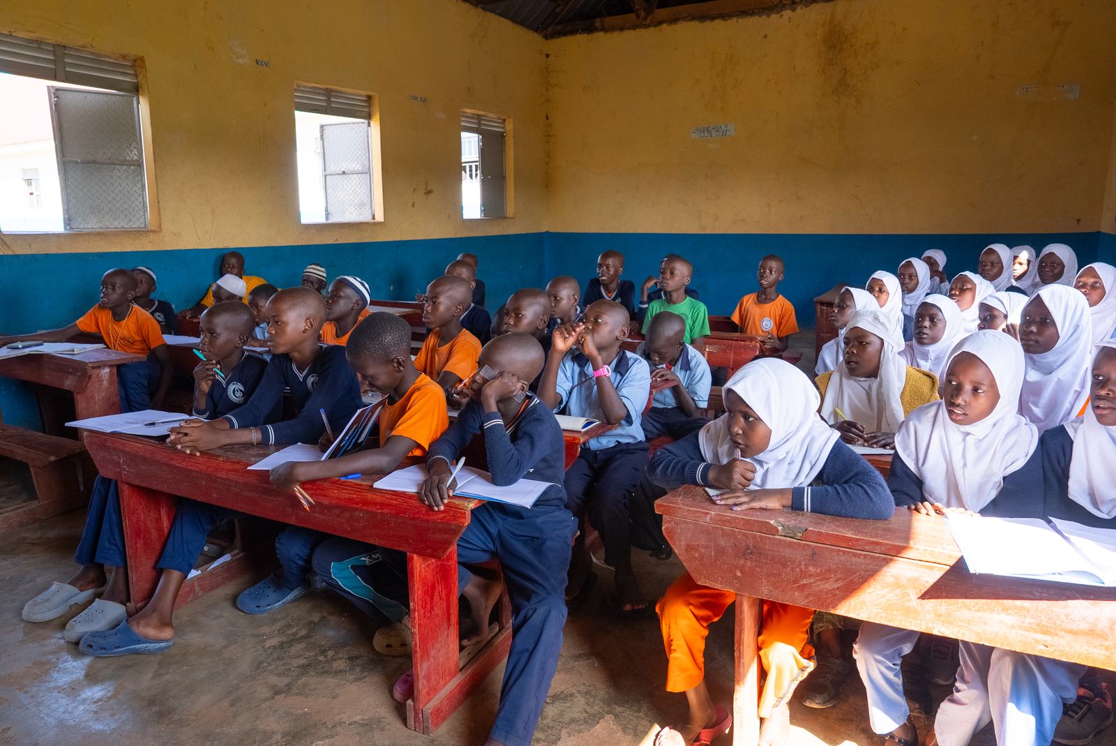 Pupils learning together in a classroom