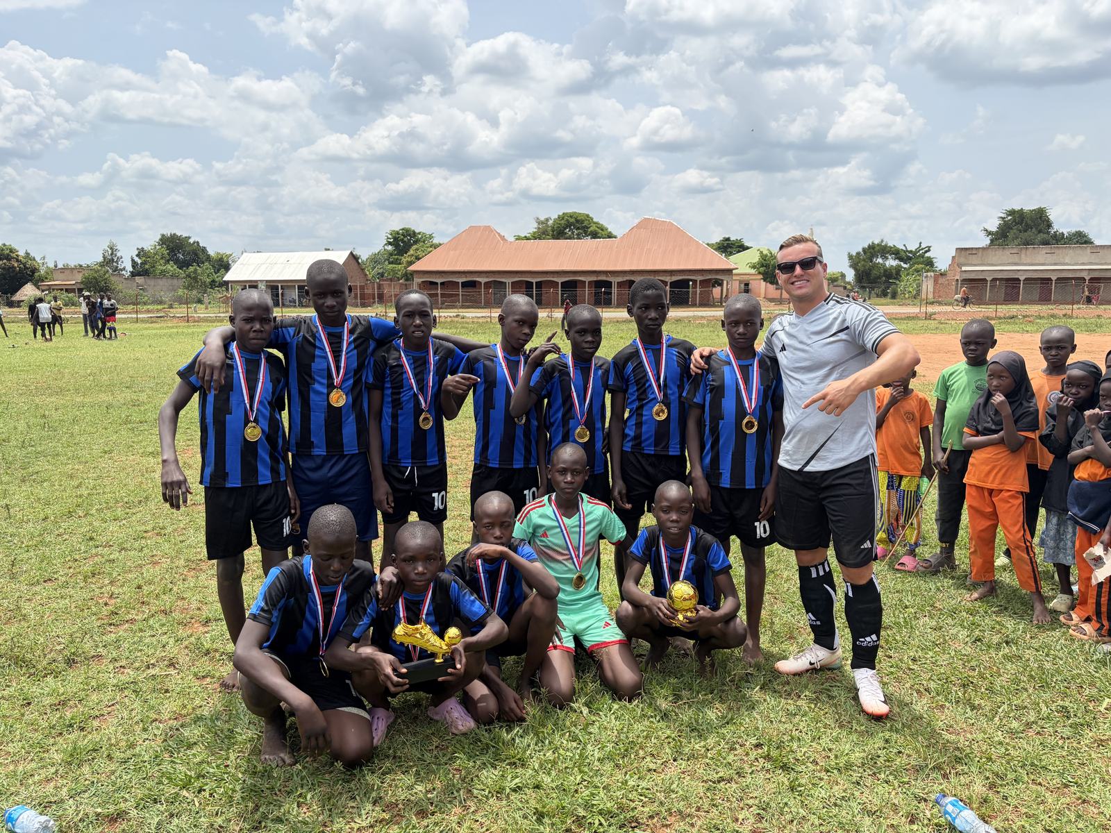 Pupils with a football trophy and medals at school