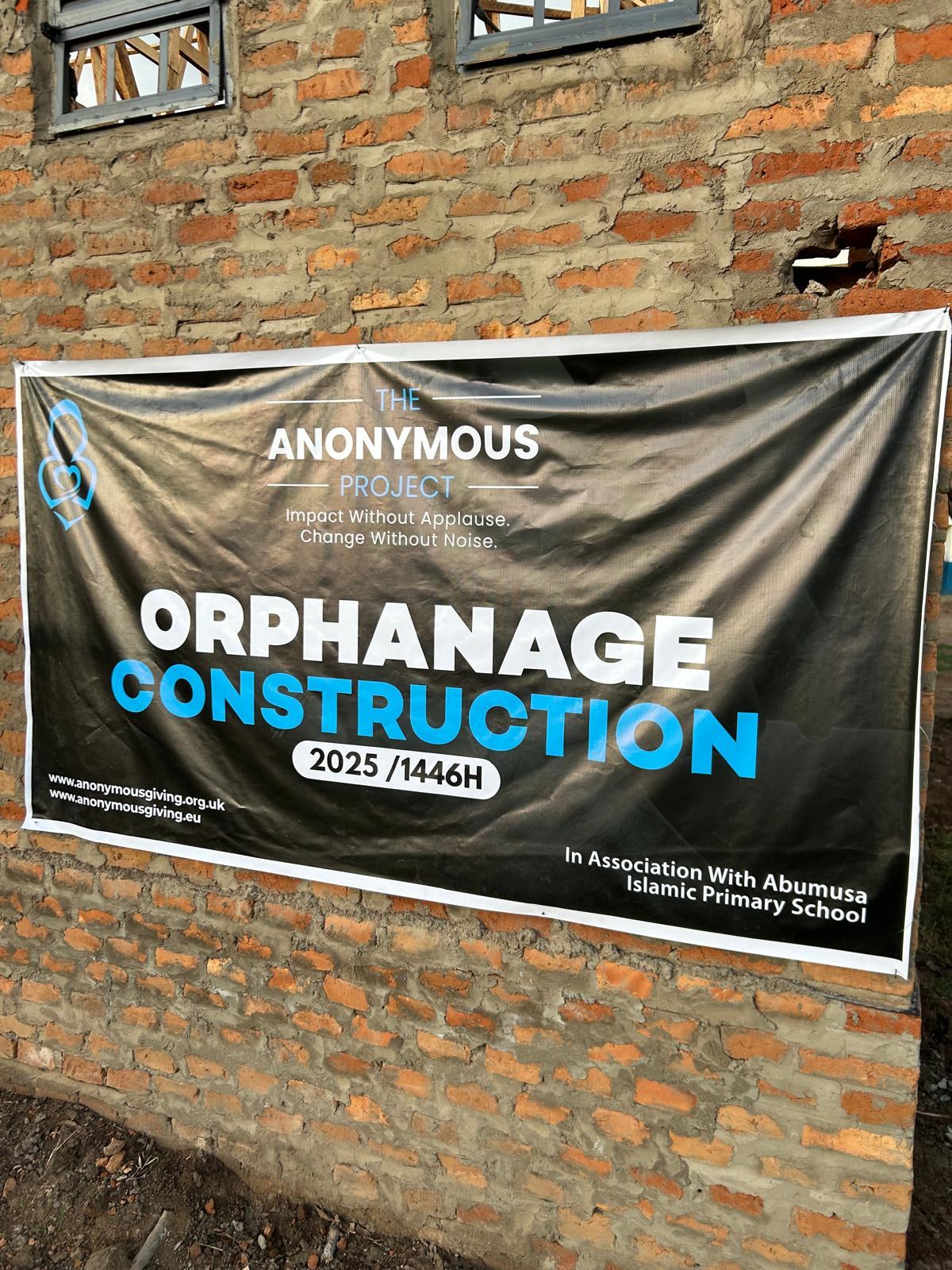 Banner outside the orphanage build at Abu Musa Islamic Primary School reading Orphanage Construction 2025