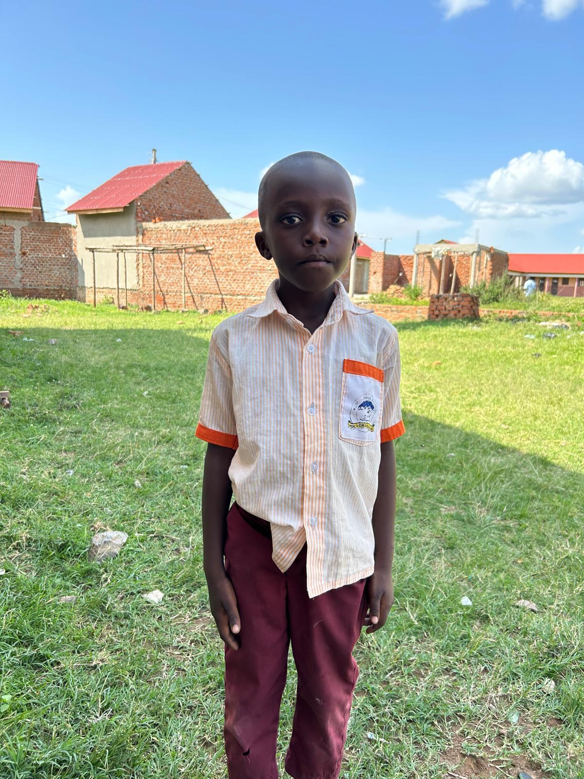 A boy standing on the school field