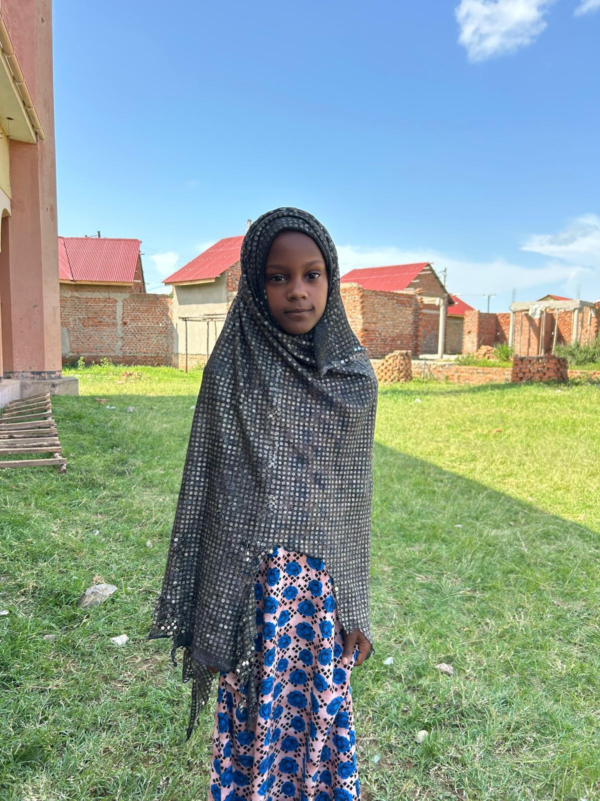 A girl standing in the school grounds